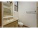Light-filled bathroom with tiled shower and granite vanity at 7150 N 64Th Pl, Paradise Valley, AZ 85253