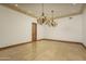 Elegant dining room featuring a large chandelier and tile floors at 7150 N 64Th Pl, Paradise Valley, AZ 85253