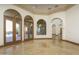 Bright and spacious interior with arched doorways and tile floors at 7150 N 64Th Pl, Paradise Valley, AZ 85253