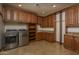 Spacious laundry room with wood cabinets and modern appliances at 7150 N 64Th Pl, Paradise Valley, AZ 85253