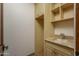 Laundry room with built-in cabinets and granite countertop at 7150 N 64Th Pl, Paradise Valley, AZ 85253