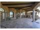 Spacious covered patio with stone flooring; fireplace and ceiling fans at 7150 N 64Th Pl, Paradise Valley, AZ 85253