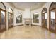 Bright sitting room with fireplace and arched windows at 7150 N 64Th Pl, Paradise Valley, AZ 85253
