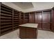 Large walk-in closet with custom shelving and hanging rods at 7150 N 64Th Pl, Paradise Valley, AZ 85253