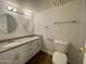 Updated bathroom with dual sink vanity, granite countertop, and modern fixtures at 8403 E Fairmount Ave, Scottsdale, AZ 85251