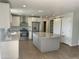 Bright kitchen with stainless steel appliances, white cabinets, and an island with granite countertop at 8403 E Fairmount Ave, Scottsdale, AZ 85251