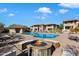 Community pool with fire pit and lounge chairs at 8880 E Paraiso Dr # 108, Scottsdale, AZ 85255