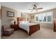 Bright bedroom with a wooden bed frame and plenty of natural light at 1113 W Fir Tree Rd, Queen Creek, AZ 85140