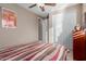 Bedroom with striped bedding and double door closet at 1113 W Fir Tree Rd, Queen Creek, AZ 85140