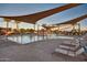 Community pool with a separate area and shade structures at 1113 W Fir Tree Rd, Queen Creek, AZ 85140