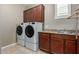 Laundry room with washer, dryer, and cabinets at 1113 W Fir Tree Rd, Queen Creek, AZ 85140