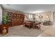Spacious living room featuring a large wooden cabinet and comfortable seating at 1113 W Fir Tree Rd, Queen Creek, AZ 85140