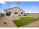Beautiful backyard featuring a fire pit, artificial turf, and low-maintenance desert landscaping at 1167 W Chimes Tower Dr, Casa Grande, AZ 85122