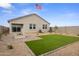 Beautiful backyard featuring a fire pit, artificial turf, and low-maintenance desert landscaping at 1167 W Chimes Tower Dr, Casa Grande, AZ 85122