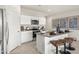 Well-lit kitchen featuring granite countertops, stainless steel appliances, white cabinets and island with bar stool seating at 1167 W Chimes Tower Dr, Casa Grande, AZ 85122