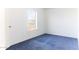 Simple bedroom with blue carpet and a window at 12866 W Sun Ave, Eloy, AZ 85131