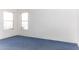 Bright bedroom with two windows and blue carpet at 12866 W Sun Ave, Eloy, AZ 85131