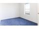 Spacious bedroom with blue carpet and window at 12866 W Sun Ave, Eloy, AZ 85131