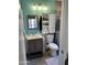Cozy bathroom featuring a wood vanity, storage, and accent wall at 1424 E Kerry Ln, Phoenix, AZ 85024