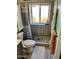 Cozy bathroom featuring a shower with a river rock floor and a bright, frosted window at 1424 E Kerry Ln, Phoenix, AZ 85024