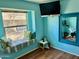 Bedroom with window bench, vibrant blue walls, and unique mirror at 1424 E Kerry Ln, Phoenix, AZ 85024