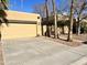 View of a two-car garage with a driveway and mature palm trees at 1424 E Kerry Ln, Phoenix, AZ 85024