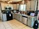 A kitchen featuring granite countertops, modern appliances, and red brick accents at 1424 E Kerry Ln, Phoenix, AZ 85024