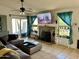 Cozy living room with large sectional sofa, fireplace, ceiling fan, and bright natural light at 1424 E Kerry Ln, Phoenix, AZ 85024