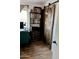 Office featuring a wooden sliding barn door and a built-in bookshelf at 1424 E Kerry Ln, Phoenix, AZ 85024