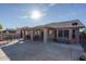 Large backyard with covered patio, BBQ area, and seating at 14416 W Kiowa Trl, Surprise, AZ 85374