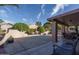 Spacious backyard patio with seating area and lush landscaping at 14416 W Kiowa Trl, Surprise, AZ 85374