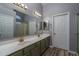 Double vanity bathroom with a large mirror and updated fixtures at 14416 W Kiowa Trl, Surprise, AZ 85374