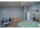 Bedroom with a dresser, ceiling fan, and access to bathroom at 14416 W Kiowa Trl, Surprise, AZ 85374