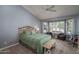 Spacious bedroom with bay window, ceiling fan and sitting area at 14416 W Kiowa Trl, Surprise, AZ 85374