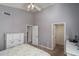 Bedroom with a dresser, ceiling fan, and walk-in closet at 14416 W Kiowa Trl, Surprise, AZ 85374