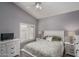 Bedroom with a queen bed, ceiling fan, and window shutters at 14416 W Kiowa Trl, Surprise, AZ 85374