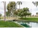 Wooden footbridge over canal with lush landscaping at 14416 W Kiowa Trl, Surprise, AZ 85374