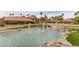Resort-style pool and spa with lush landscaping and a pond at 14416 W Kiowa Trl, Surprise, AZ 85374