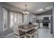 Kitchen with white cabinets, stainless steel appliances, and breakfast nook at 14416 W Kiowa Trl, Surprise, AZ 85374