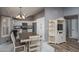 Eat-in kitchen with white cabinets and wood flooring at 14416 W Kiowa Trl, Surprise, AZ 85374