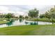 Serene lake view with lush green landscaping at 14416 W Kiowa Trl, Surprise, AZ 85374
