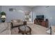 Living room with large TV and plenty of seating at 14416 W Kiowa Trl, Surprise, AZ 85374