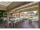 Community patio with tables and chairs near pool at 14416 W Kiowa Trl, Surprise, AZ 85374