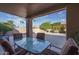 Covered patio with seating area, views of landscaped backyard at 14416 W Kiowa Trl, Surprise, AZ 85374