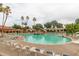 Community pool with a rock waterfall feature and ample lounge space at 14416 W Kiowa Trl, Surprise, AZ 85374