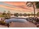 Relaxing pool with a waterfall feature and lake view at 1671 W Crescent Way, Chandler, AZ 85248