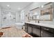 Spa-like bathroom with soaking tub, walk-in shower, and dual vanities at 17255 W Seldon Ln, Waddell, AZ 85355