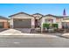 Single-story home with a two-car garage and landscaping at 17255 W Seldon Ln, Waddell, AZ 85355