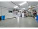 Organized garage with overhead storage and epoxy flooring at 17255 W Seldon Ln, Waddell, AZ 85355