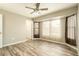 Bright bedroom with wood-look floors, ceiling fan, and window seating at 17824 N Azurite Dr, Sun City West, AZ 85375